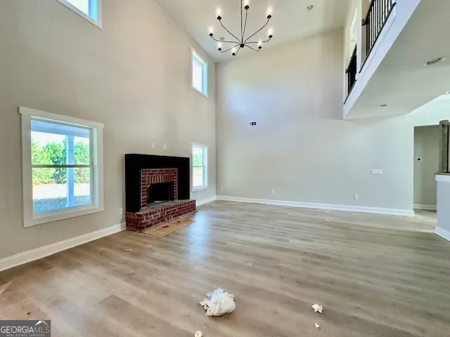 a view of an empty room with a window and fireplace