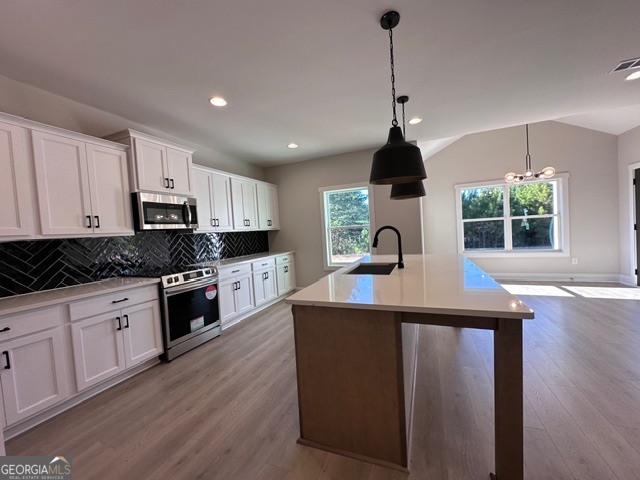 3647 Youngs Mill Road Hogansville, GA 30230 - Photo 10 of 34 a kitchen with kitchen island granite countertop a stove a sink a center island and wooden floor