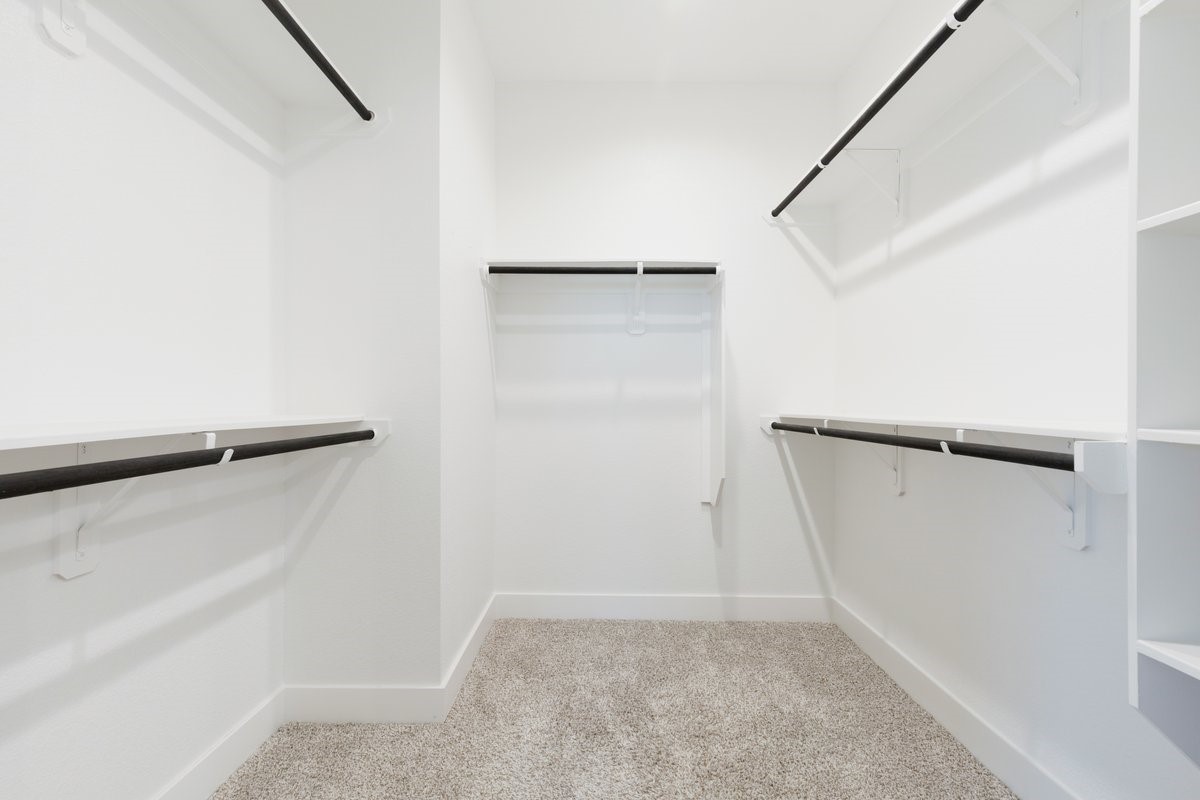 10122 Crescendo Way Manvel, TX 77578 - Photo 14 of 24 a view of walk in closet with empty racks