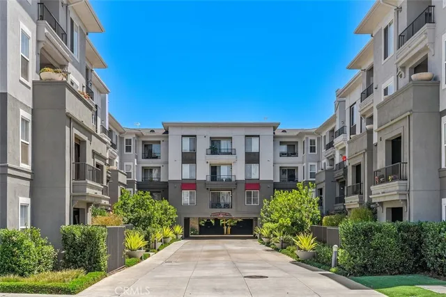 a front view of a multi story building with yard