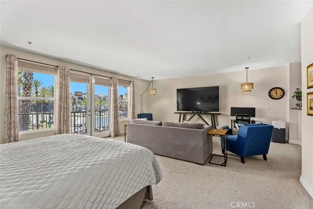 a bedroom with a bed and flat screen tv