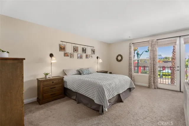 a bedroom with a bed next to a window