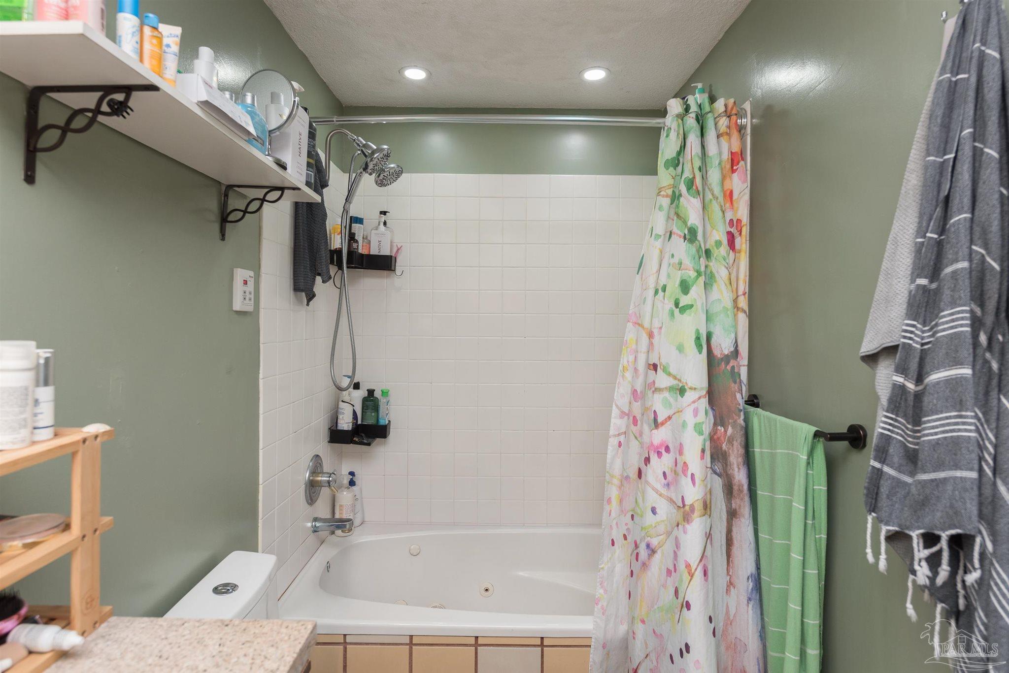 2322 Silversides Loop Pensacola, FL 32526 - Photo 11 of 29 a bathroom with a shower curtain and a sink