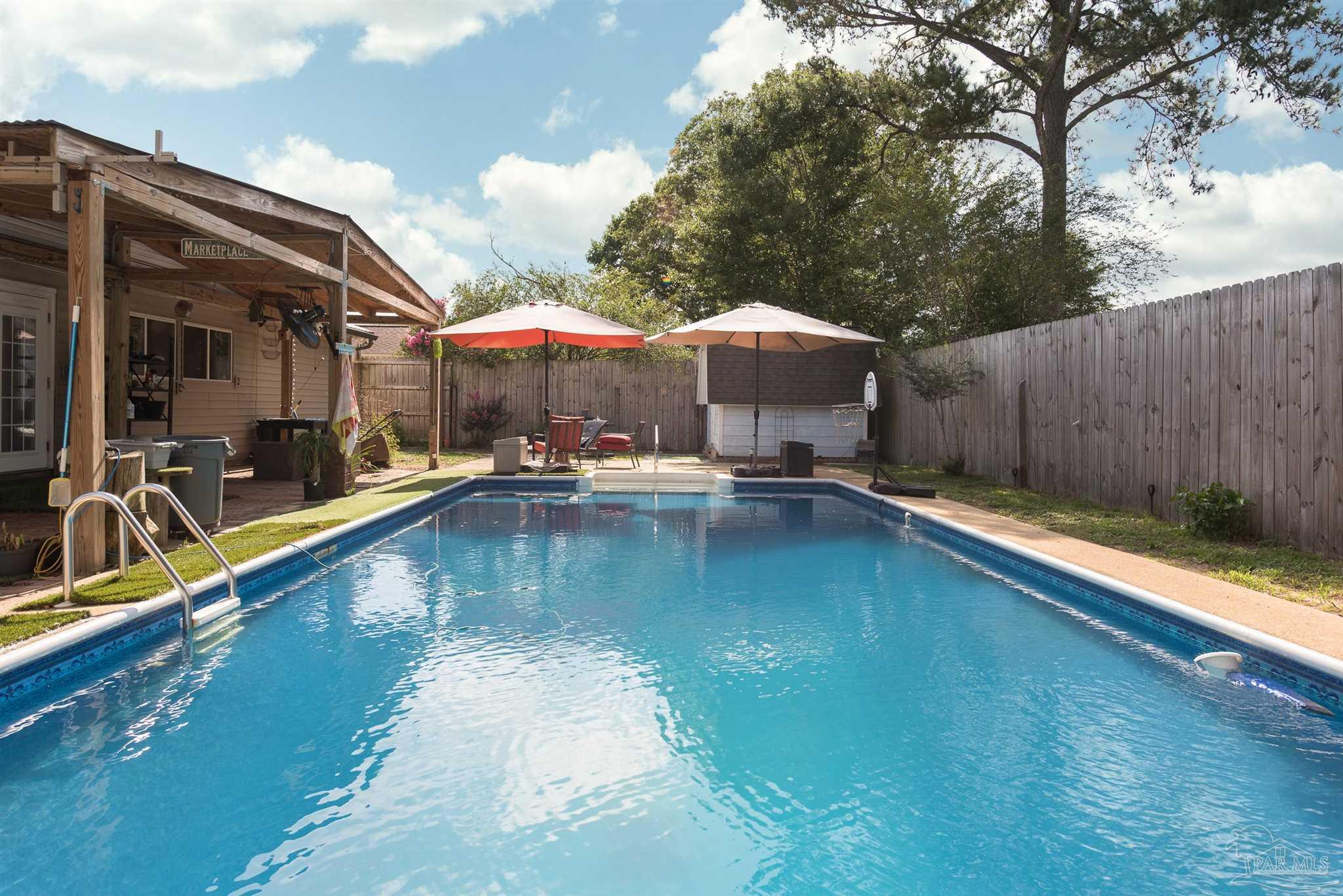 2322 Silversides Loop Pensacola, FL 32526 - Photo 23 of 29 a swimming pool with outdoor seating and yard