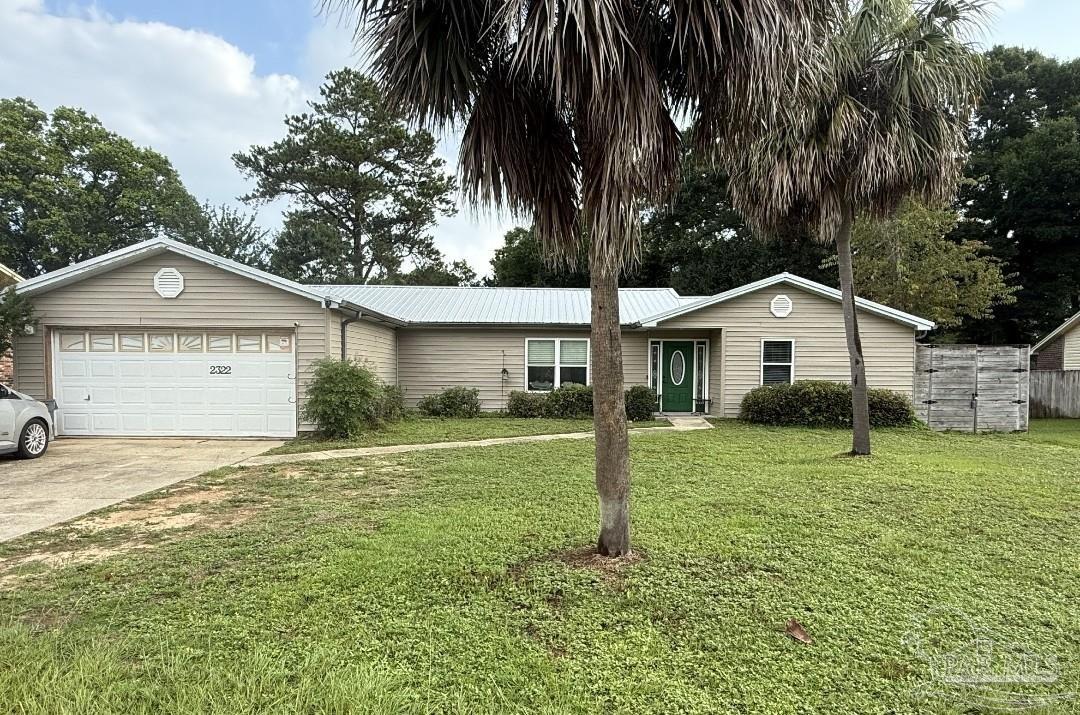 2322 Silversides Loop Pensacola, FL 32526 - Photo 29 of 29 a front view of a house with a yard and garage