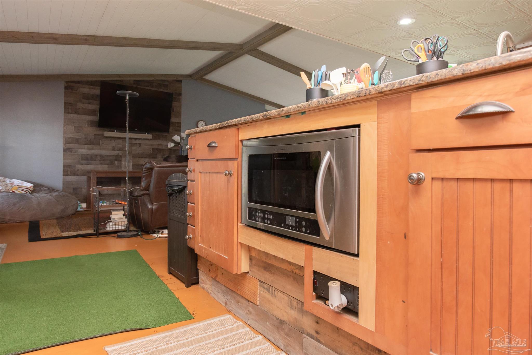 2322 Silversides Loop Pensacola, FL 32526 - Photo 4 of 29 a view of kitchen with stainless steel appliances wooden floor dining table and chairs