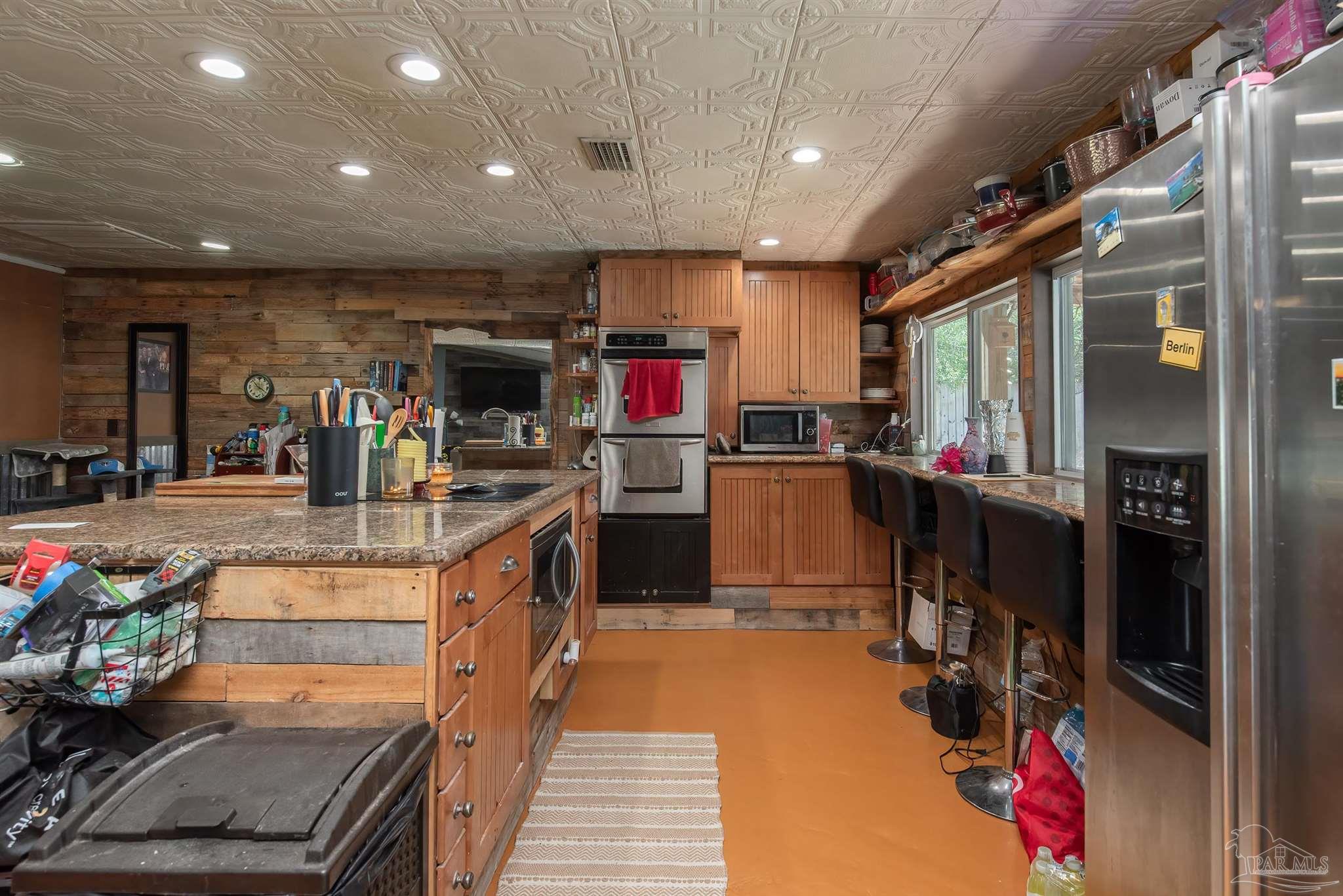 2322 Silversides Loop Pensacola, FL 32526 - Photo 6 of 29 a kitchen with kitchen island granite countertop lots of counter top space and stainless steel appliances