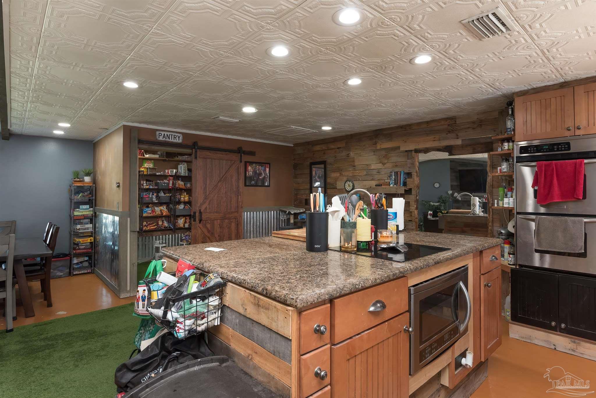 2322 Silversides Loop Pensacola, FL 32526 - Photo 7 of 29 a kitchen with stainless steel appliances granite countertop a stove and a refrigerator