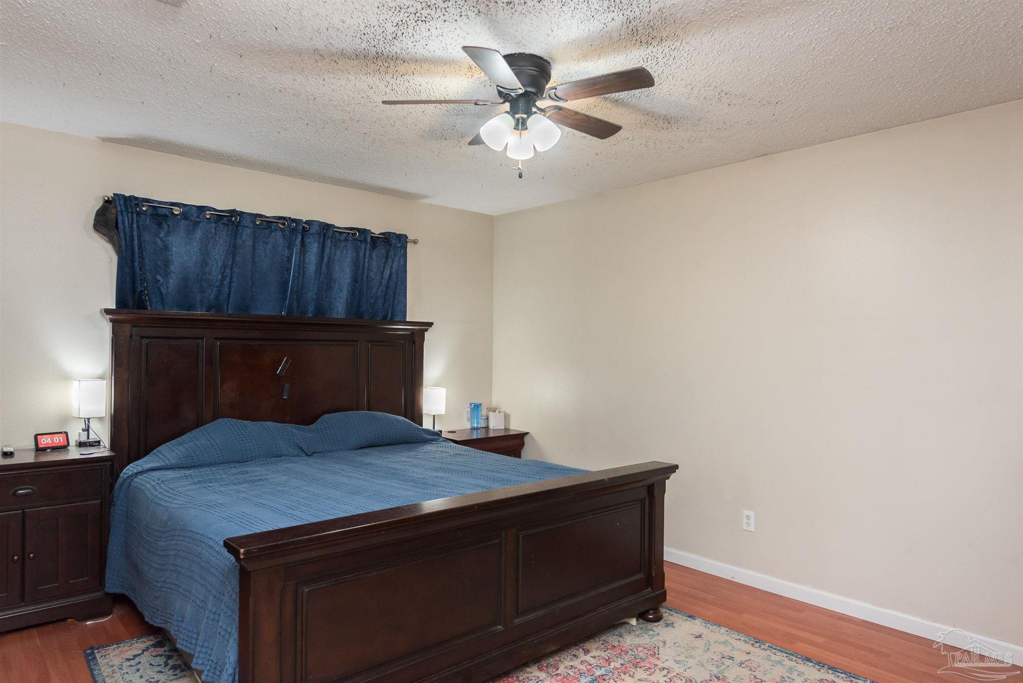 2322 Silversides Loop Pensacola, FL 32526 - Photo 8 of 29 a bedroom with a bed and a ceiling fan