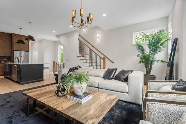 a living room with furniture potted plant and a flat screen tv