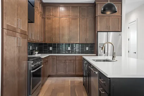 a kitchen with a sink cabinets and stainless steel appliances