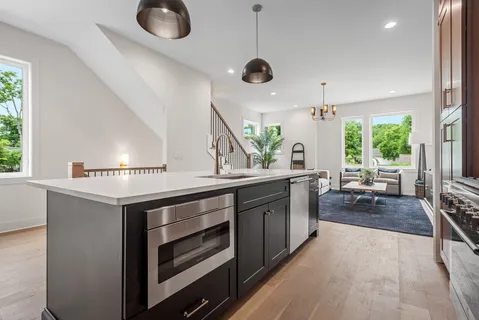 a kitchen with stainless steel appliances granite countertop a stove and a sink