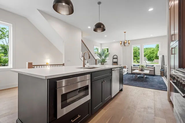 a kitchen with stainless steel appliances granite countertop a stove and a sink