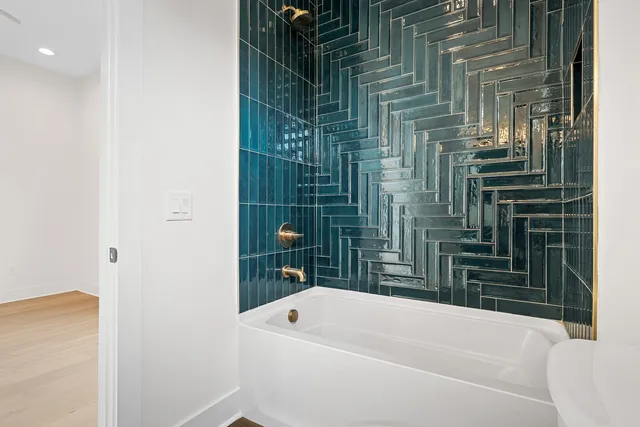 a bathroom with a bathtub and a shower