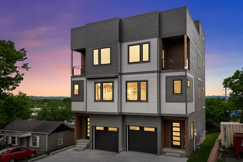 a front view of a residential apartment building with a yard