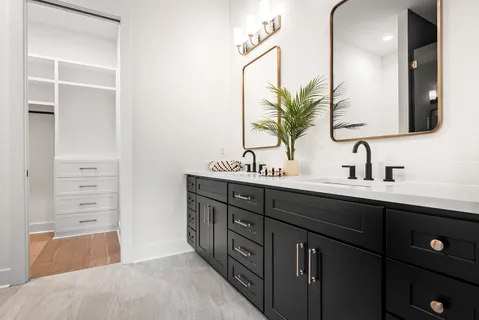 a bathroom with a double vanity sink and a mirror