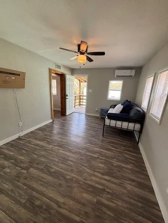 a view of a livingroom with furniture wooden floor and windows