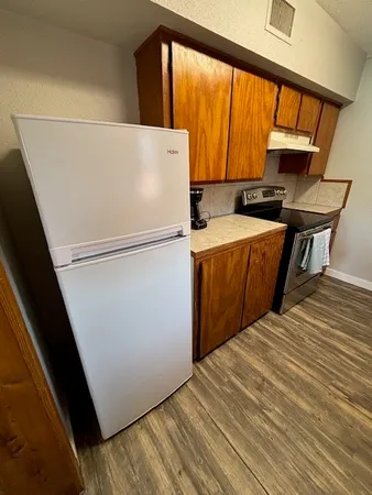 a white refrigerator freezer sitting in a kitchen