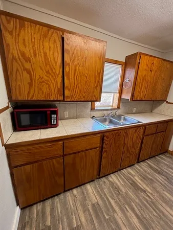 a kitchen with a sink and a refrigerator