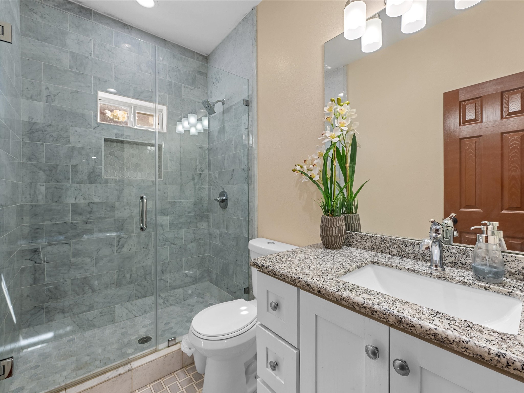 886 Zilss Road La Grange, TX 78945 - Photo 21 of 50 a bathroom with a granite countertop sink a toilet and shower
