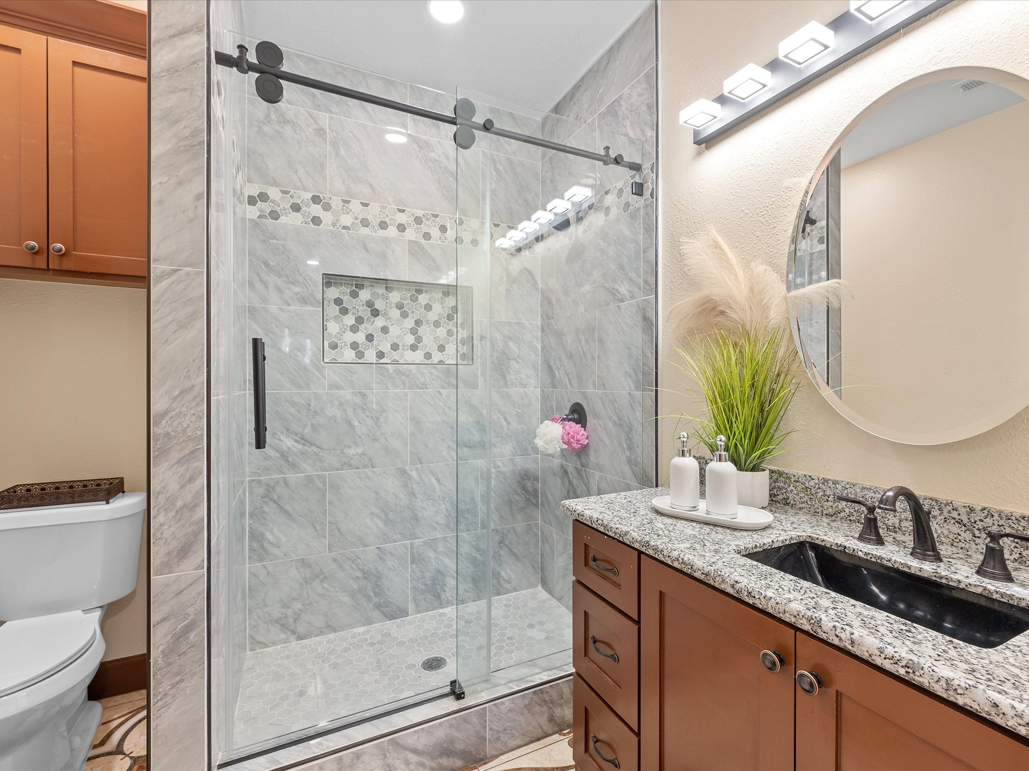 886 Zilss Road La Grange, TX 78945 - Photo 26 of 50 a bathroom with a granite countertop sink a mirror a vanity and shower