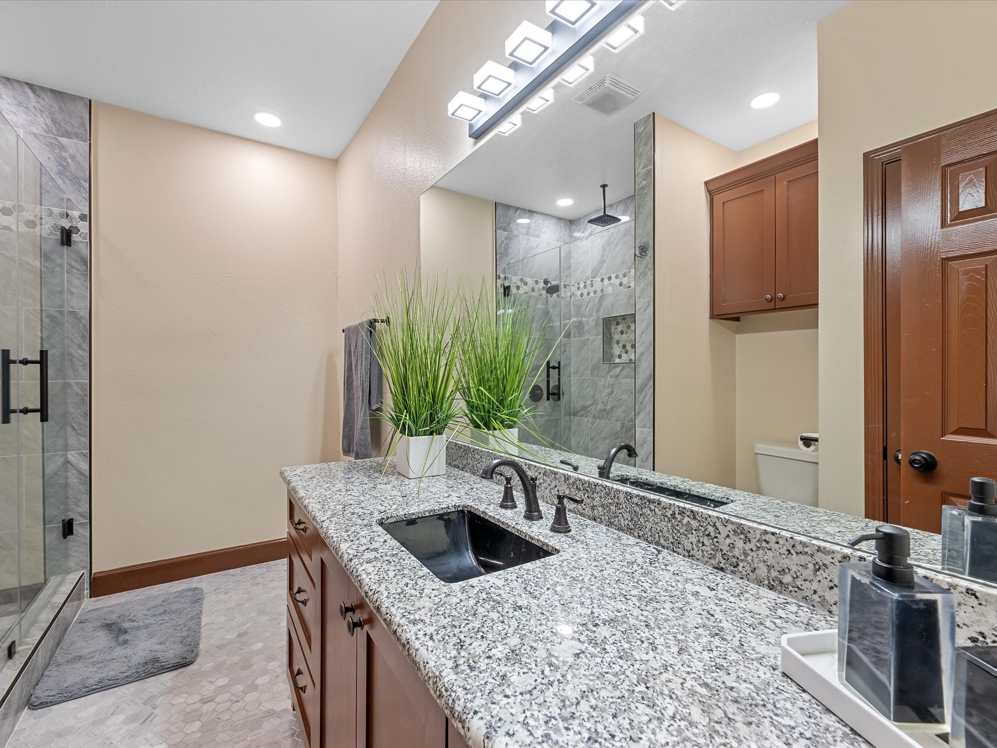 886 Zilss Road La Grange, TX 78945 - Photo 29 of 50 a bathroom with a granite countertop sink a mirror and shower