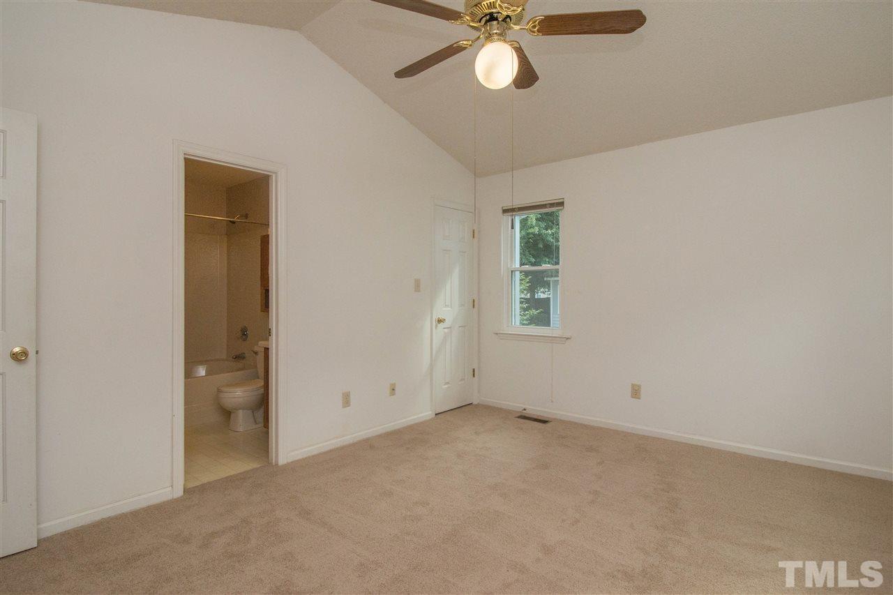 2300 Carthage Circle Raleigh, NC 27604 - Photo 13 of 18 an empty room with a chandelier fan and windows
