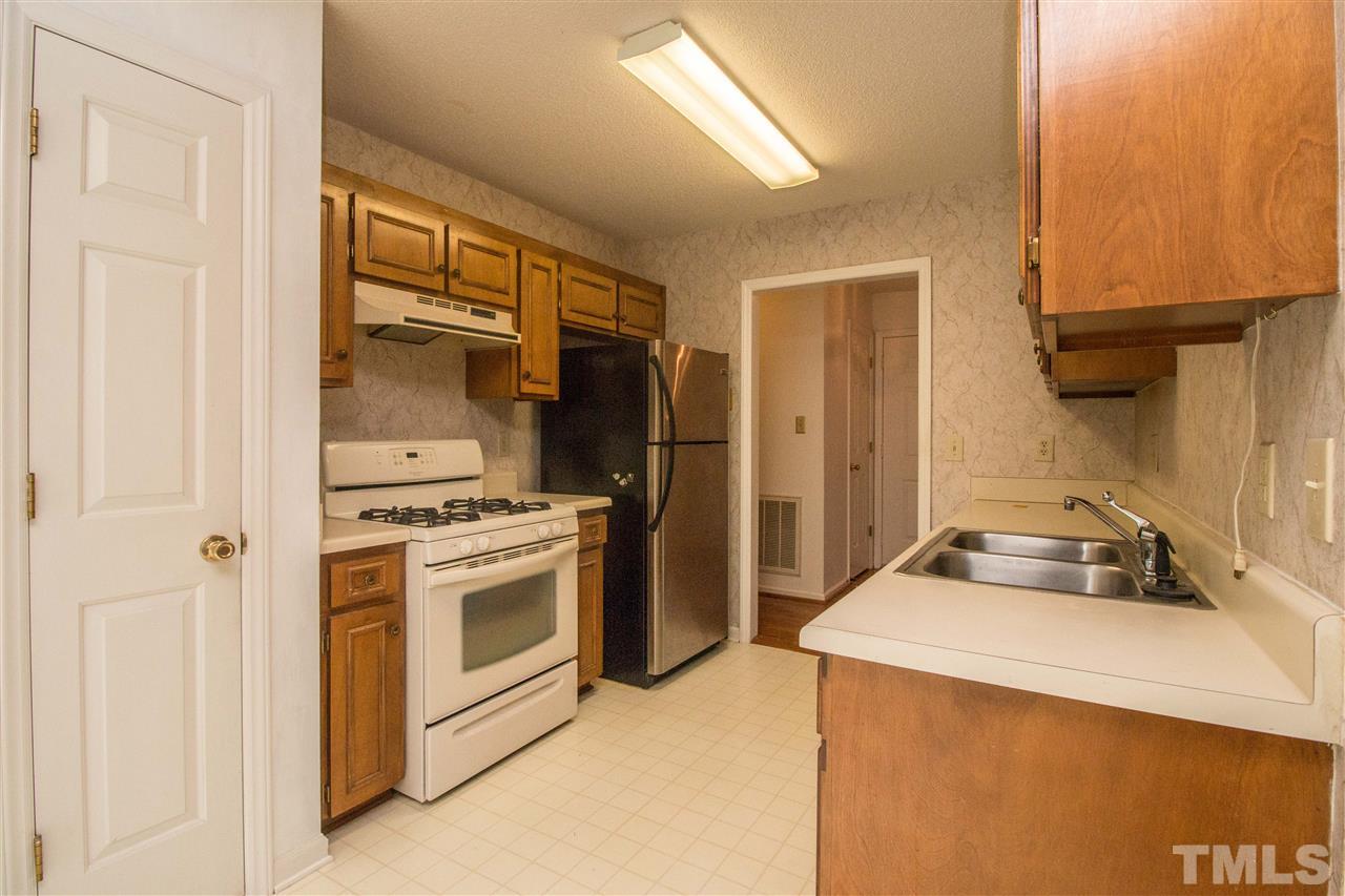 2300 Carthage Circle Raleigh, NC 27604 - Photo 8 of 18 a kitchen with a sink cabinets and stainless steel appliances