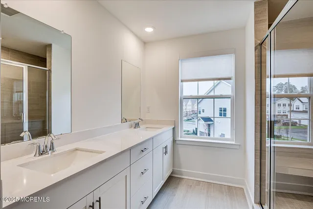 a bathroom with a granite countertop sink mirror and double