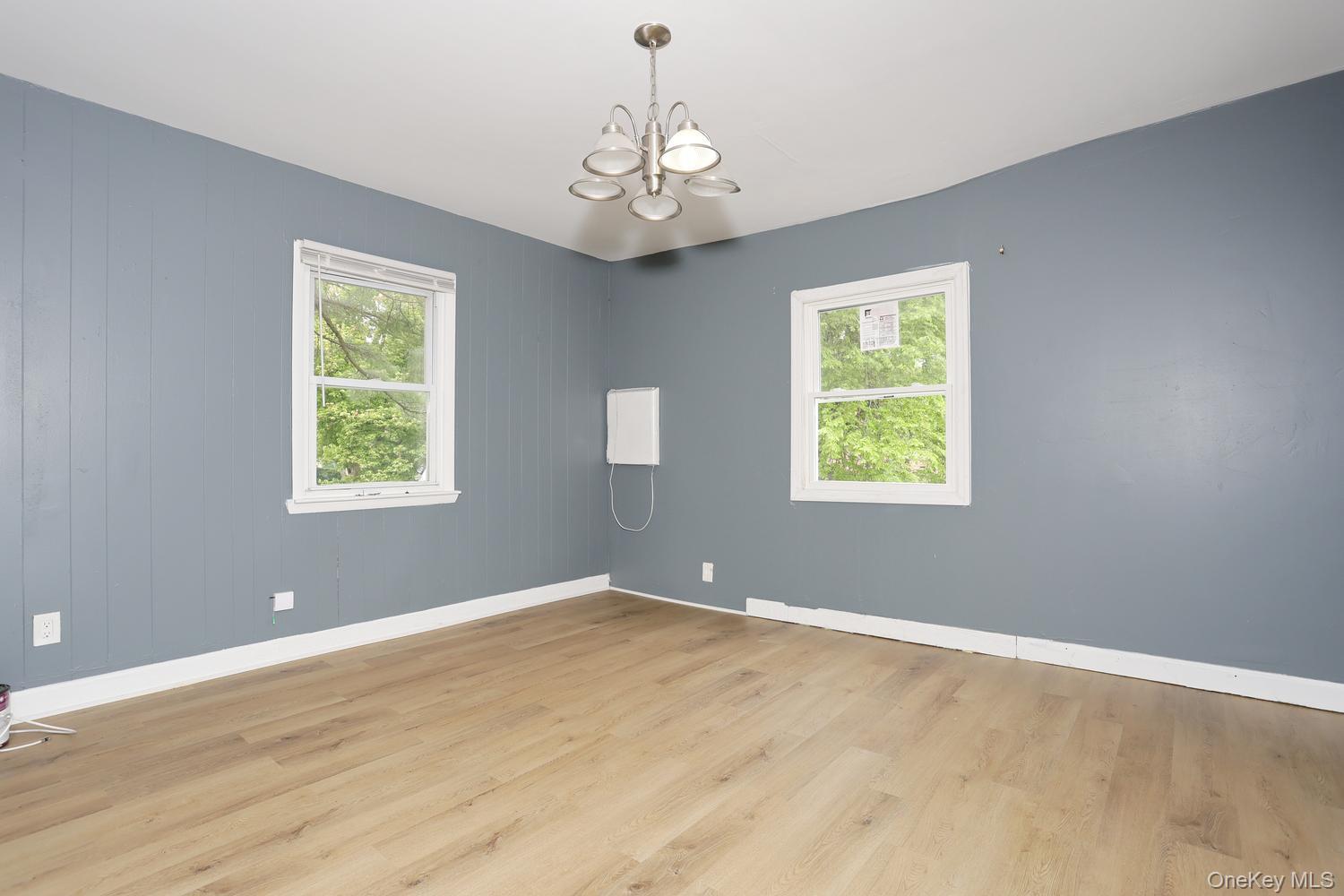 29 Fairview Avenue Spring Valley, NY 10977 - Photo 5 of 19 a view of an empty room with wooden floor and a window