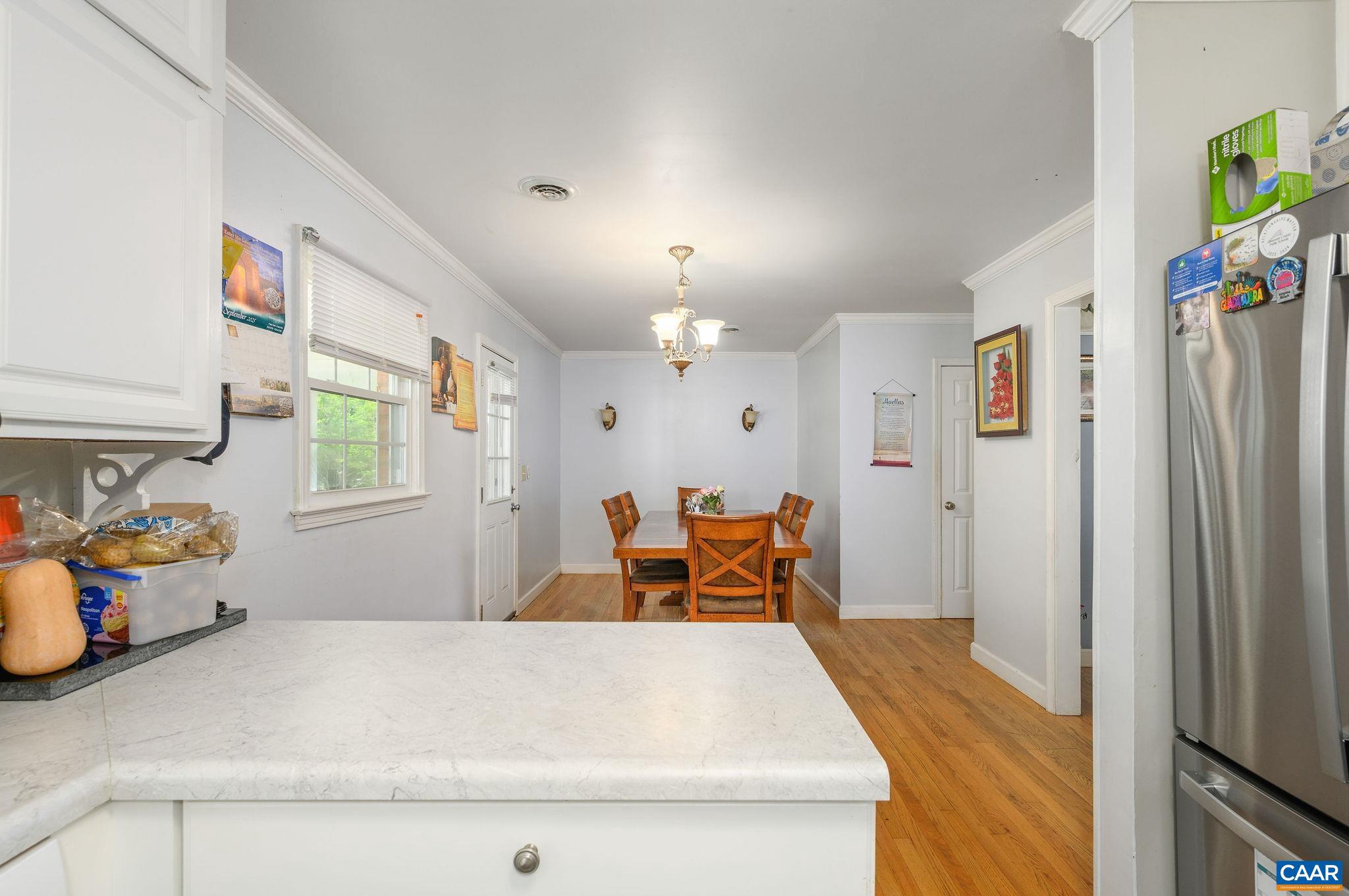 2806 Brookmere Road Charlottesville, VA 22901 - Photo 5 of 19 a bedroom with a bed and a chandelier