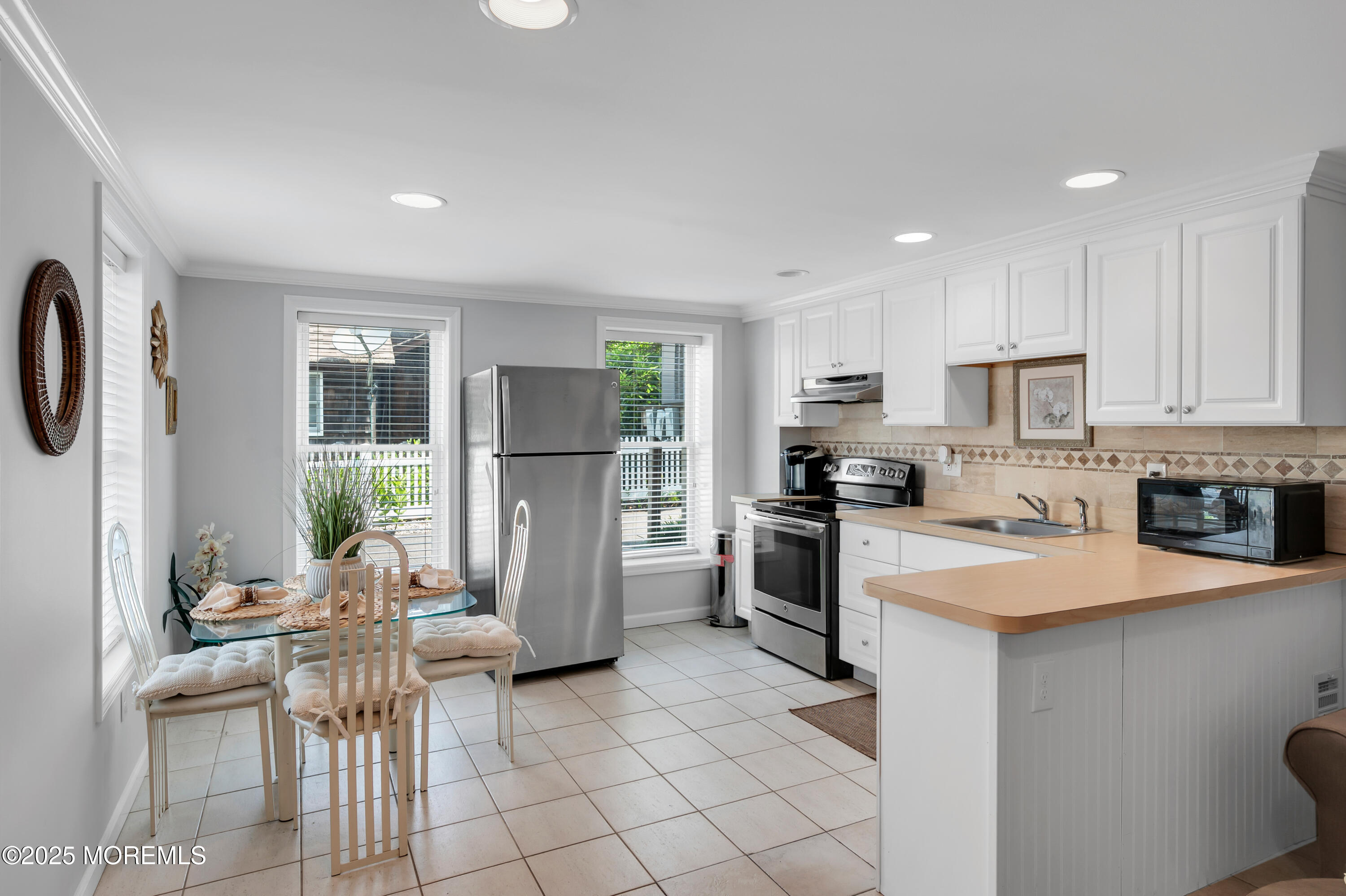 512 Main Avenue, Unit 5 Bay Head, NJ 08742 - Photo 18 of 35 a kitchen with white cabinets and stainless steel appliances