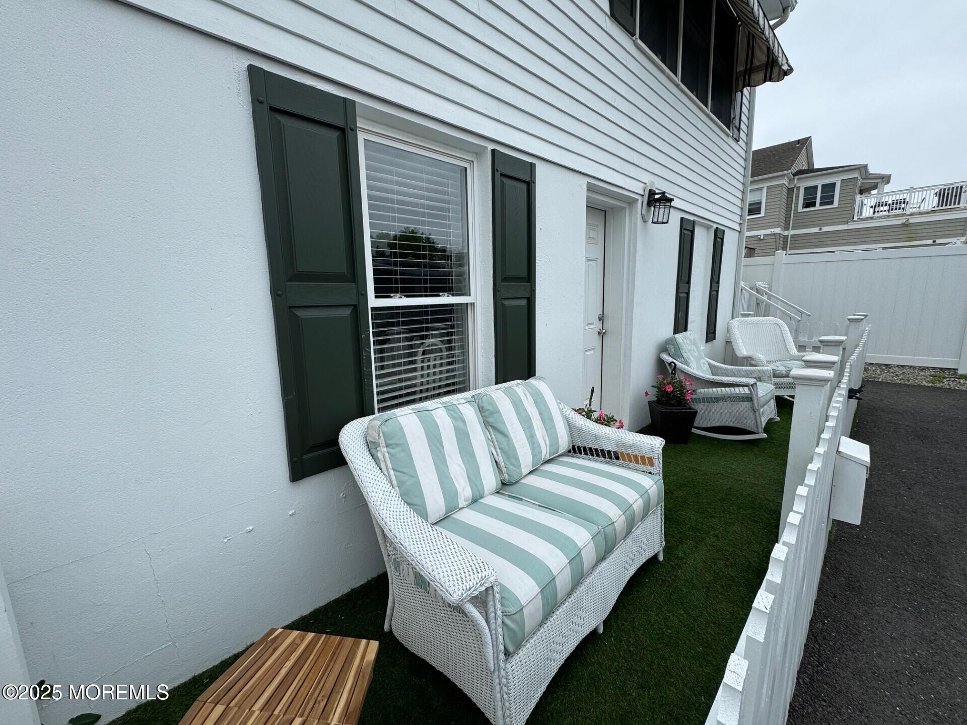 512 Main Avenue, Unit 5 Bay Head, NJ 08742 - Photo 22 of 35 a view of a patio with couches chairs potted plants and wooden floor