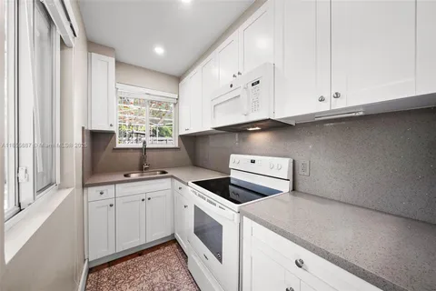 a living room with lots of furniture and a chandelier