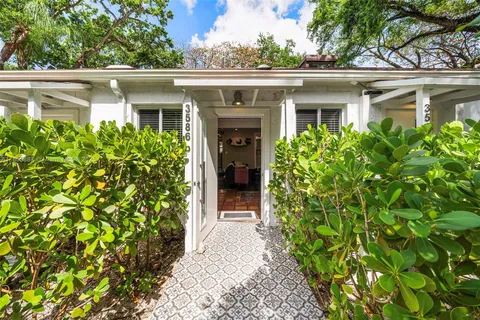 a living room with furniture and a dining table with rug floor