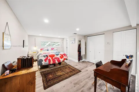a living room with furniture a rug and a kitchen