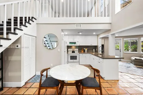 a kitchen with stainless steel appliances kitchen island granite countertop a refrigerator and a stove top oven