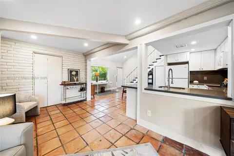 a bedroom with a bed and a flat tv screen on dresser