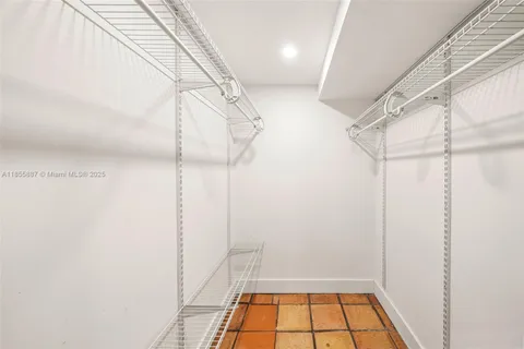 a bathroom with a sink a mirror a vanity and shower