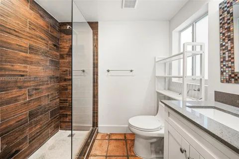 a view of a house with porch and garden