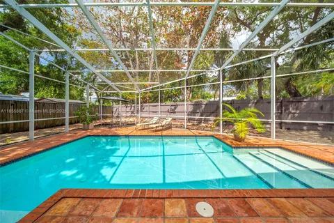 a view of a house with a yard and wooden fence