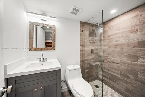a view of a bedroom with furniture and wooden floor
