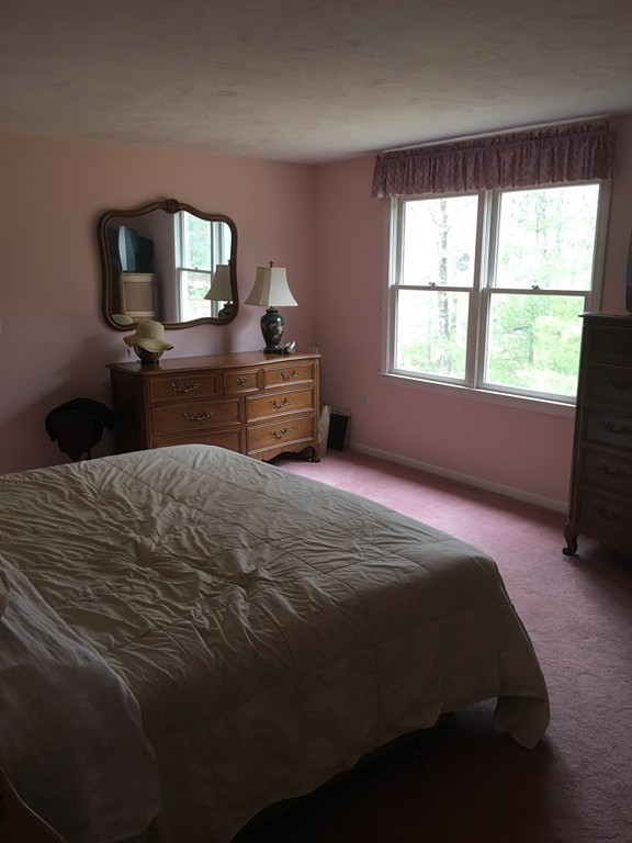 31 Country Side Road, Unit 31 Bellingham, MA 02019 - Photo 11 of 21 a bedroom with a bed and a flat tv screen on a dresser