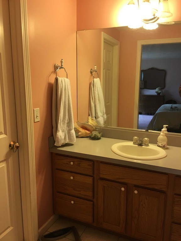 31 Country Side Road, Unit 31 Bellingham, MA 02019 - Photo 14 of 21 a bathroom with a double vanity sink and a mirror