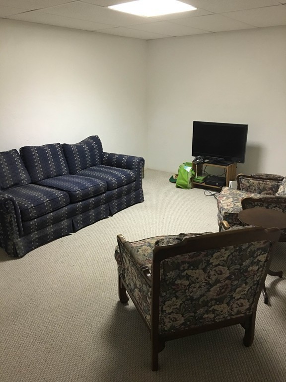 31 Country Side Road, Unit 31 Bellingham, MA 02019 - Photo 19 of 21 a living room with furniture and a flat screen tv