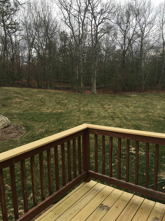 31 Country Side Road, Unit 31 Bellingham, MA 02019 - Photo 3 of 21 a balcony with wooden floor