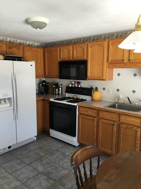 31 Country Side Road, Unit 31 Bellingham, MA 02019 - Photo 4 of 21 a kitchen with a sink cabinets and appliances