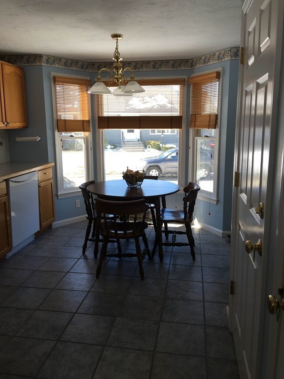31 Country Side Road, Unit 31 Bellingham, MA 02019 - Photo 6 of 21 a view of a dining room with furniture a chandelier and window