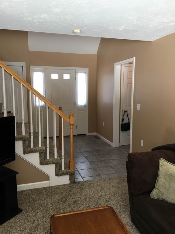 31 Country Side Road, Unit 31 Bellingham, MA 02019 - Photo 7 of 21 a living room with lots of furniture and stairs