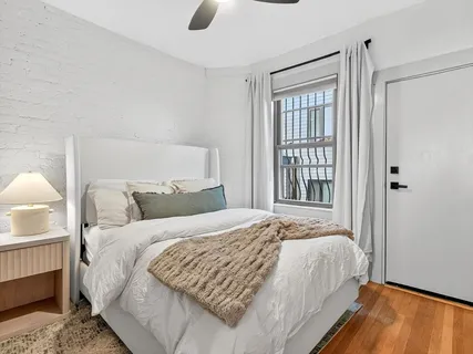 a bedroom with a bed and a window